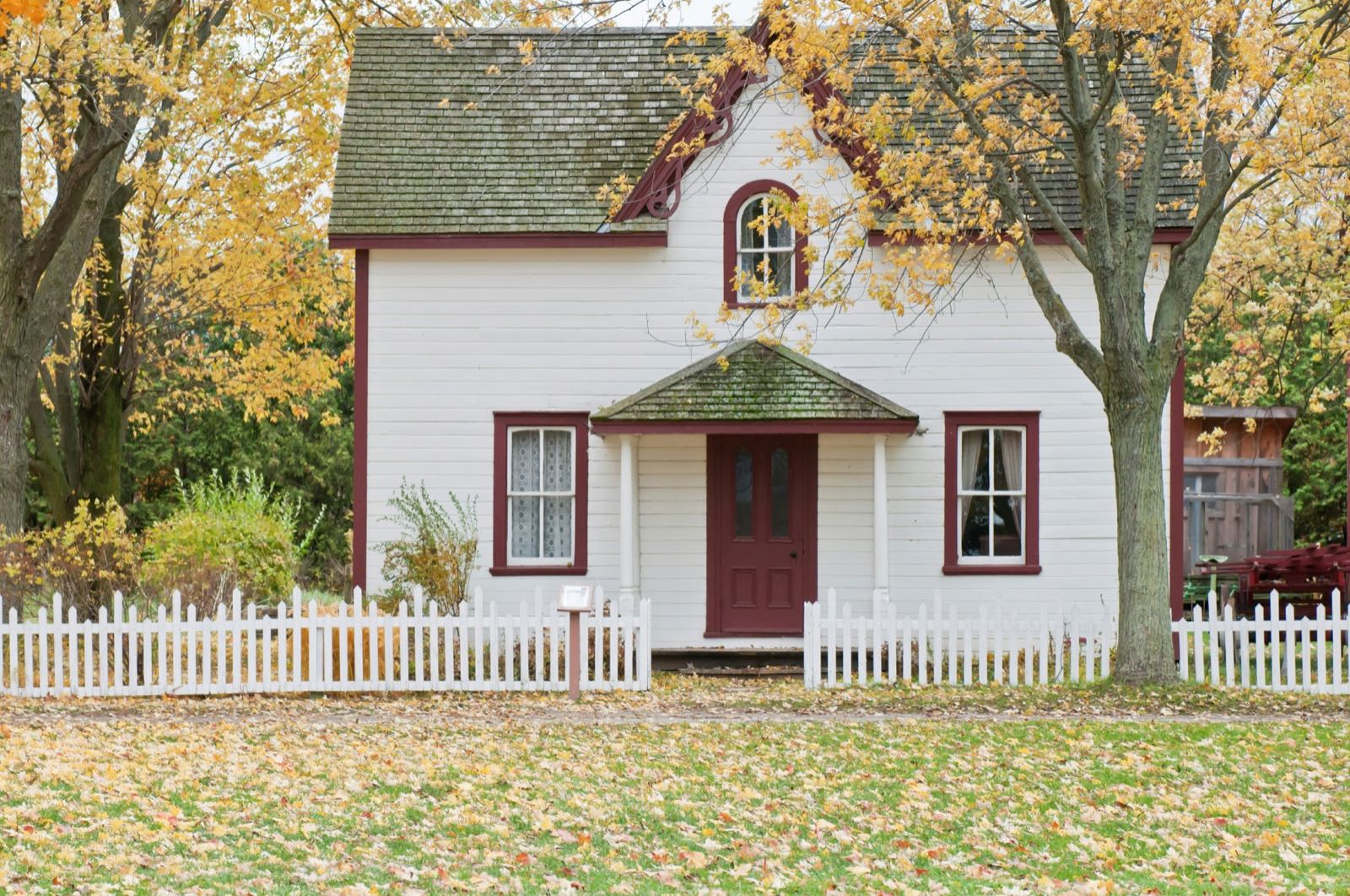 A modest home with a front porch on a quiet street
